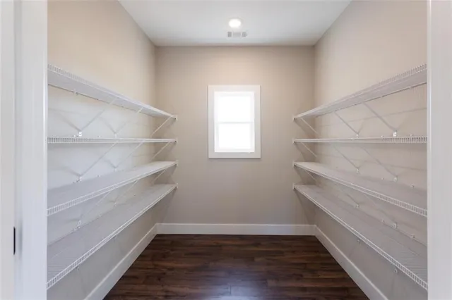 a view of walk in closet with empty racks
