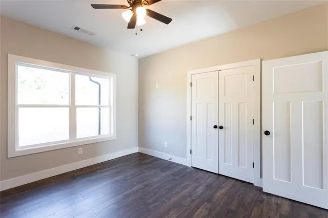 a view of an empty room and wooden floor
