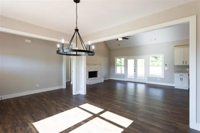a view of empty room with wooden floor and fireplace