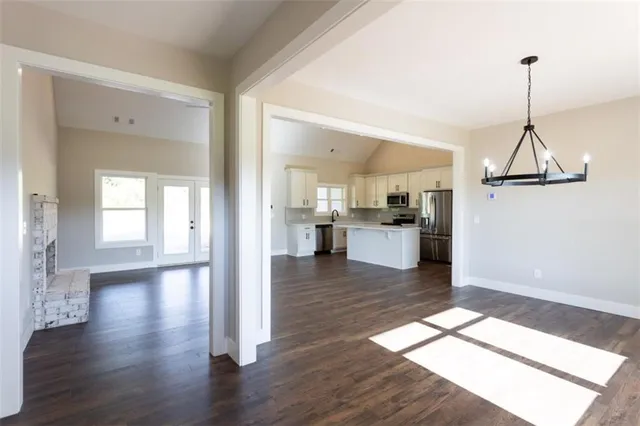 a view of a kitchen with wooden floor and a kitchen