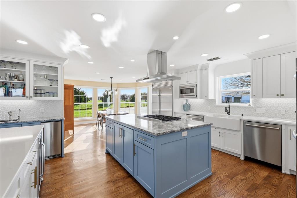 243 South King Road Heath, TX 75126 - Photo 16 of 40 a kitchen with stainless steel appliances granite countertop wooden floors and sink