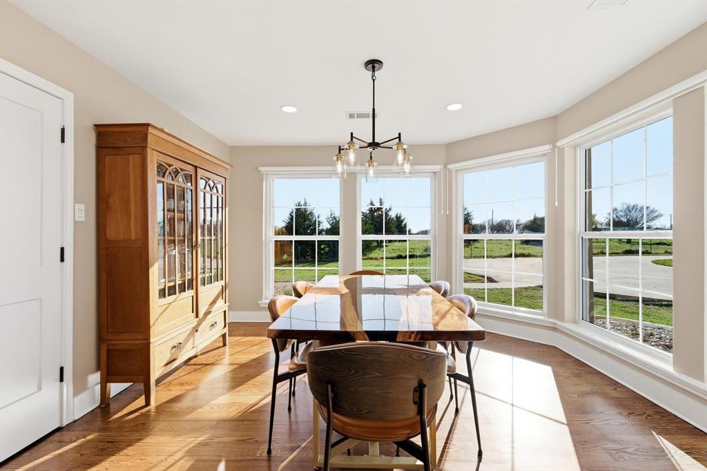 243 South King Road Heath, TX 75126 - Photo 18 of 40 a view of a dining room with furniture large windows and wooden floor