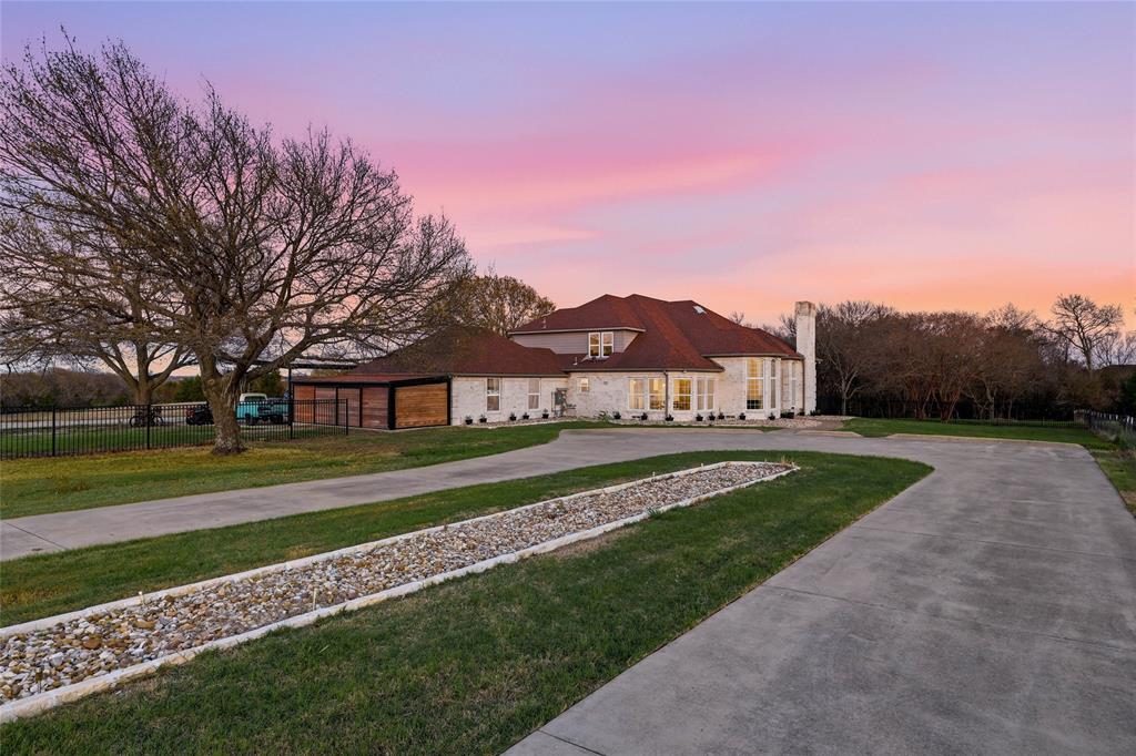 243 South King Road Heath, TX 75126 - Photo 2 of 40 a view of a house with a big yard and large trees