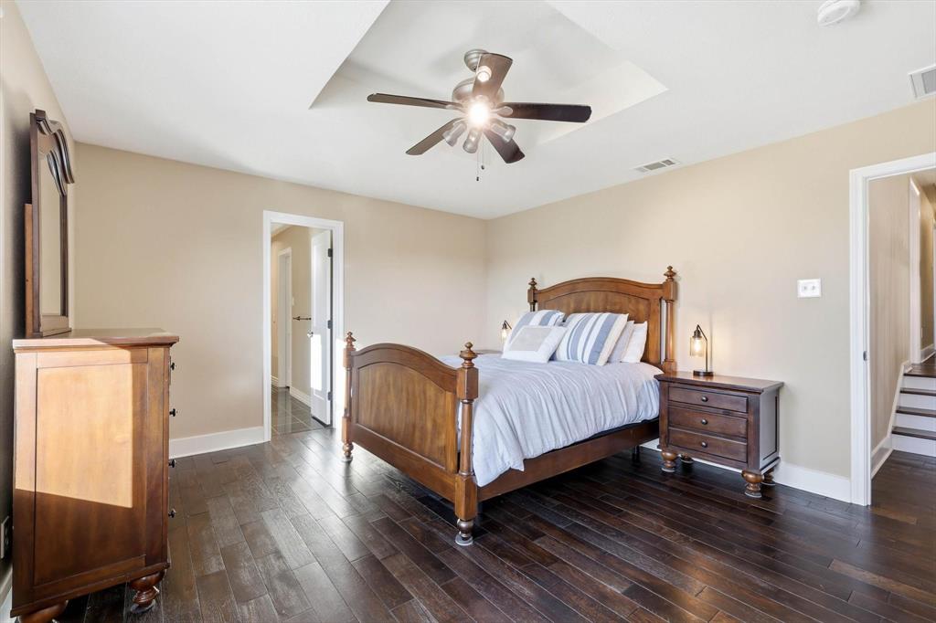 243 South King Road Heath, TX 75126 - Photo 27 of 40 a bedroom with a bed and wooden floor