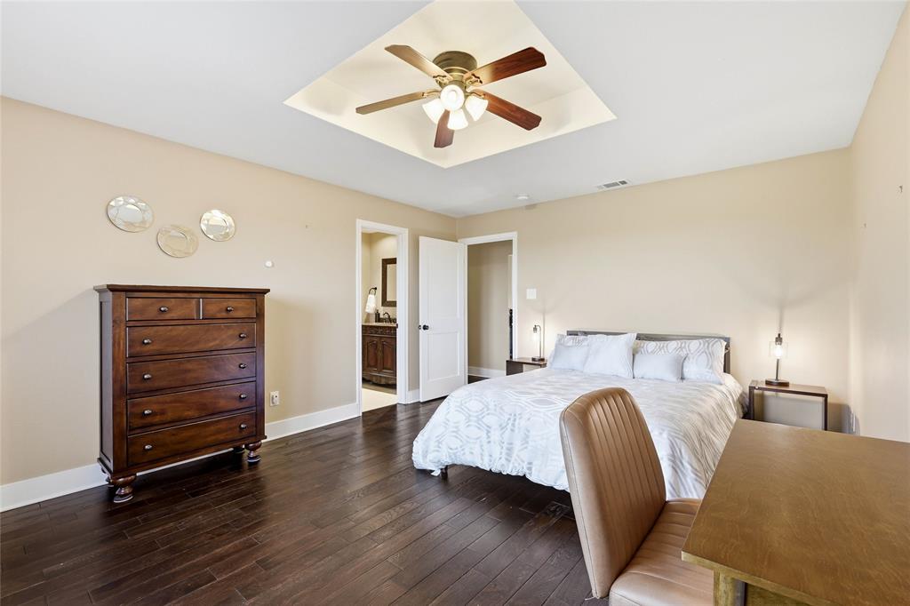 243 South King Road Heath, TX 75126 - Photo 29 of 40 a bedroom with a bed and a ceiling fan