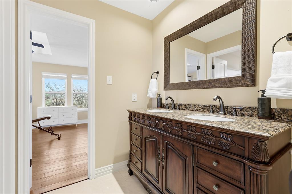 243 South King Road Heath, TX 75126 - Photo 30 of 40 a spacious bathroom with a granite countertop sink and a mirror