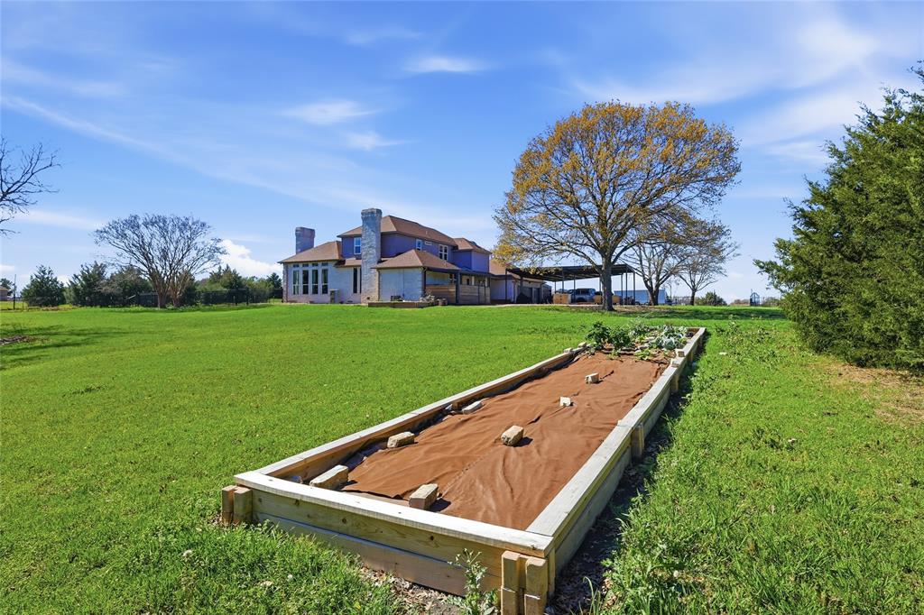 243 South King Road Heath, TX 75126 - Photo 35 of 40 a view of a back yard of the house with green space and porch