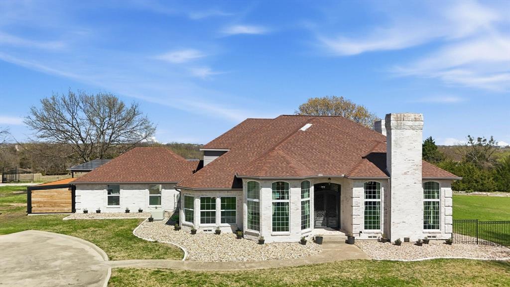 243 South King Road Heath, TX 75126 - Photo 5 of 40 a front view of a house with garden