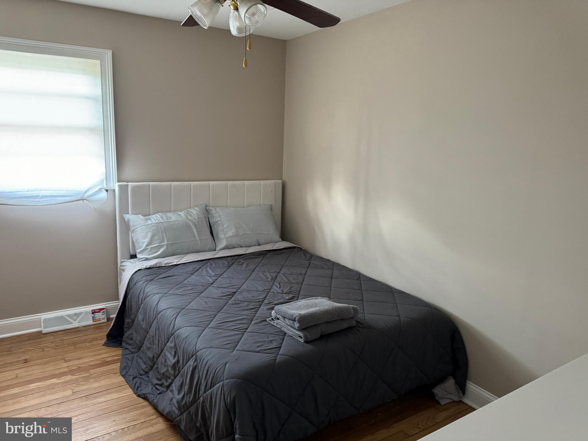 2006 A Avenue Atco, NJ 08004 - Photo 5 of 14 a bed sitting in a bedroom next to a window
