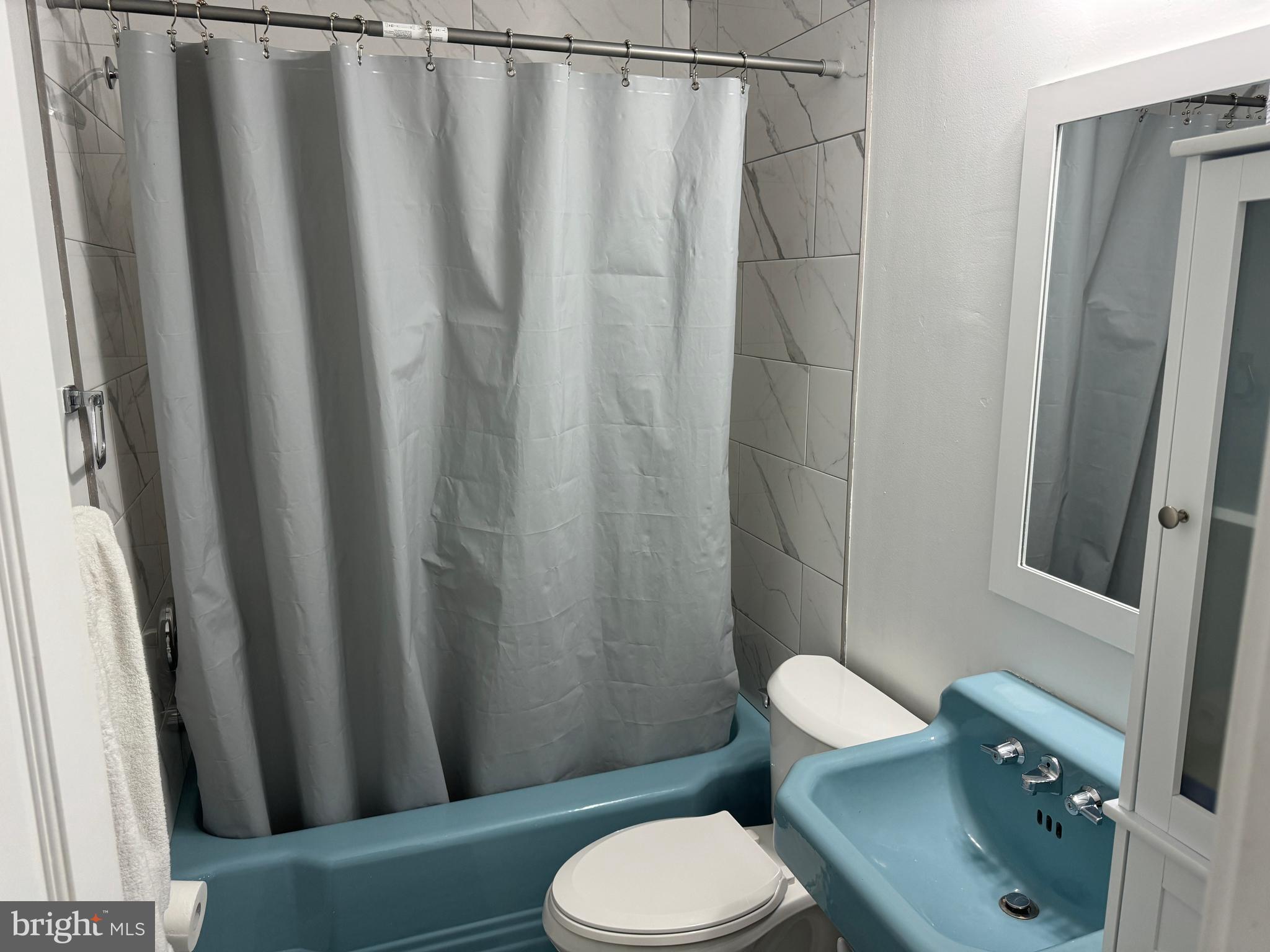 2006 A Avenue Atco, NJ 08004 - Photo 9 of 14 a white toilet sitting next to a shower curtain