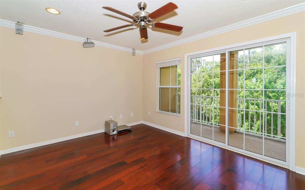 7339 Black Walnut Way Lakewood Ranch, FL 34202 - Photo 2 of 27 a room with window wooden floor and a ceiling fan