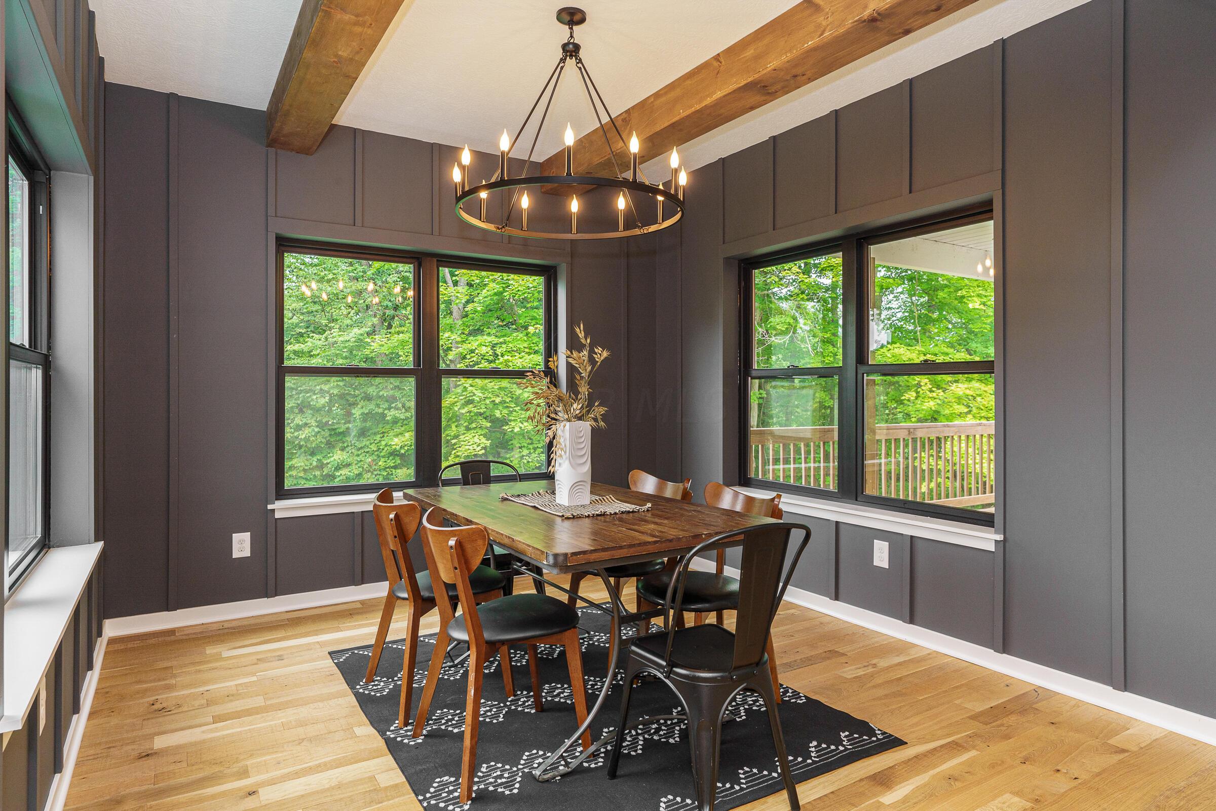 701 Ross Road Sunbury, OH 43074 - Photo 19 of 74 The dining room with windows on three sides and a rustic chandelier is perfect for your next dinner party or holiday feast