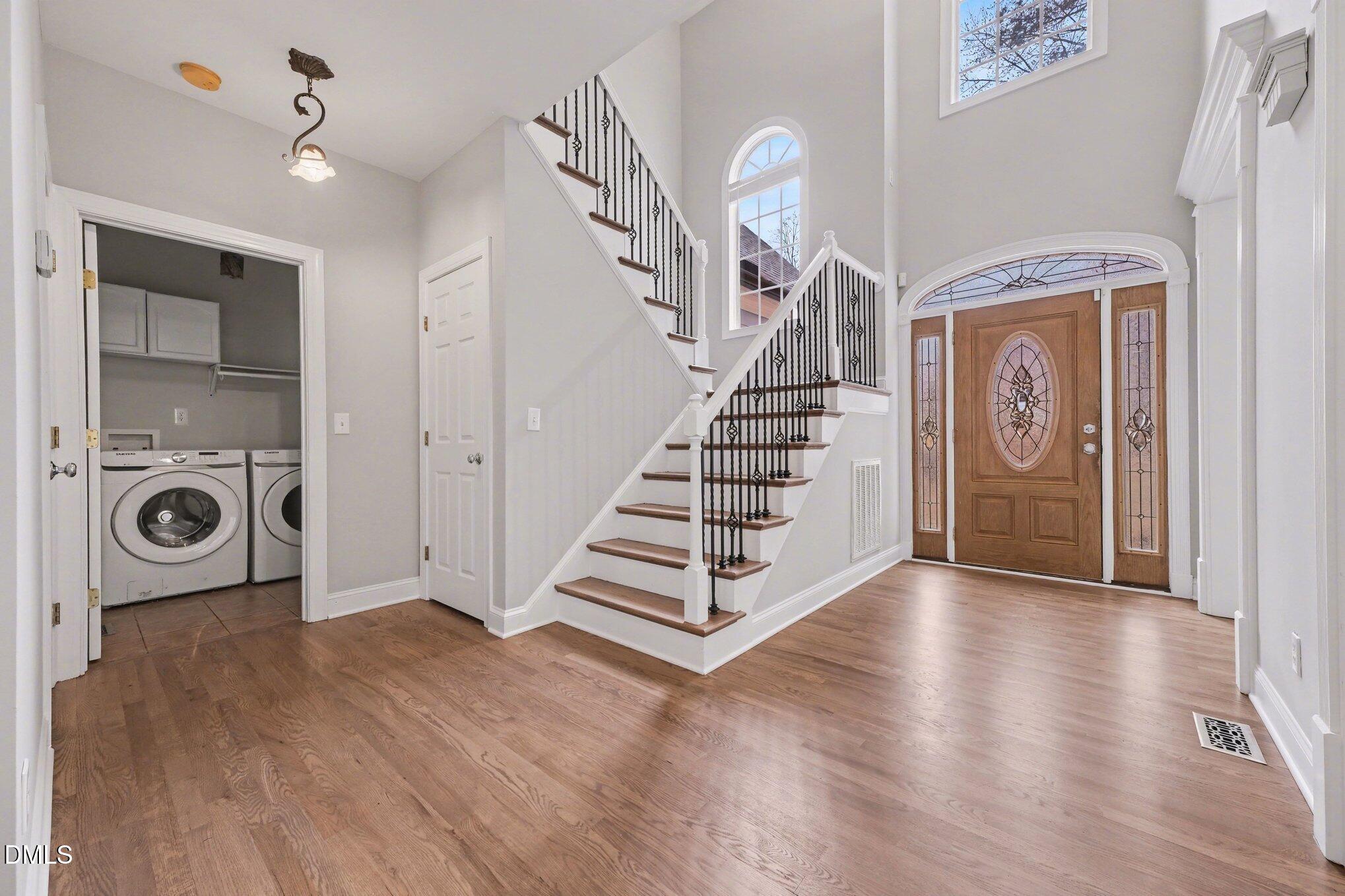 4613 Cherrybark Lane Raleigh, NC 27616 - Photo 5 of 27 a view of a hallway with entryway wooden floor and front door