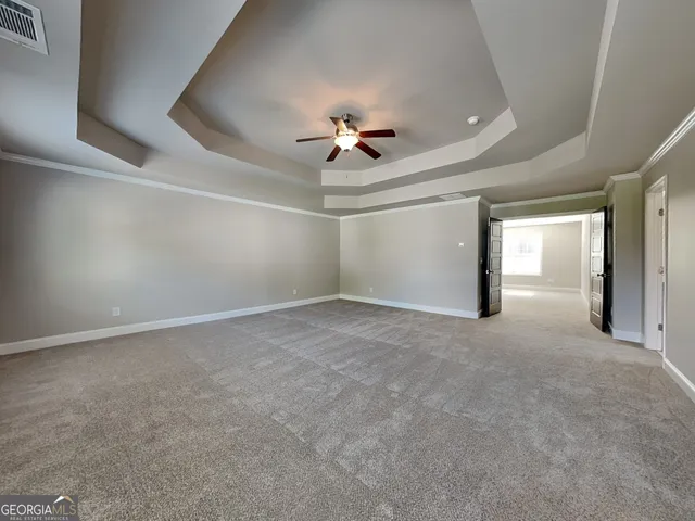 a view of a livingroom with a ceiling fan and window