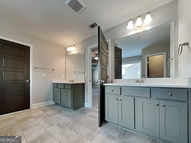 a kitchen with a refrigerator and a sink