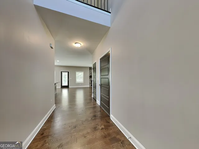a view of hallway with wooden floor