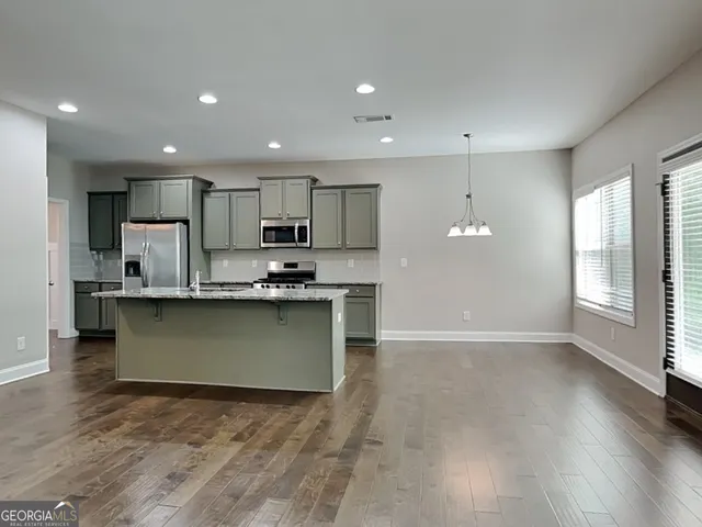 a kitchen with a refrigerator and a microwave