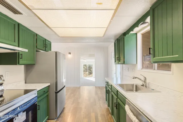 a kitchen with a sink stove and cabinets