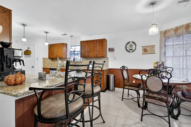 a dining room with furniture and a window