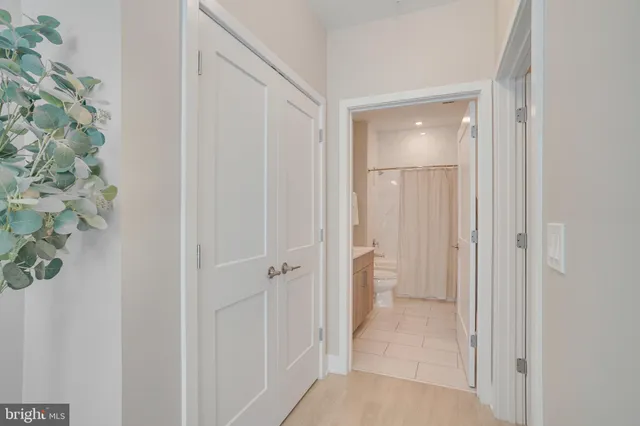 a spacious bedroom with a large bed and a chandelier