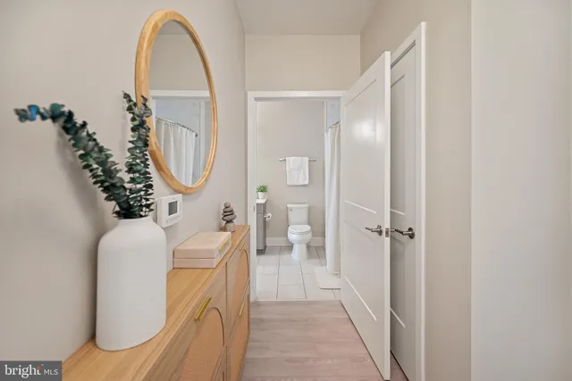 a bathroom with a granite countertop sink toilet a large mirror and shower