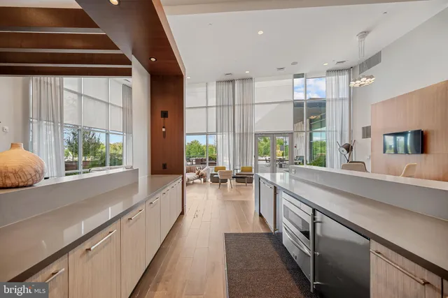 a living room with a bed furniture and a large window