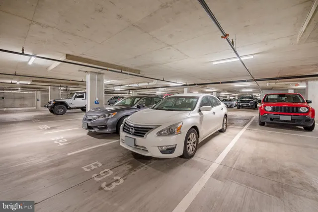 a view of parking garage with cars parked