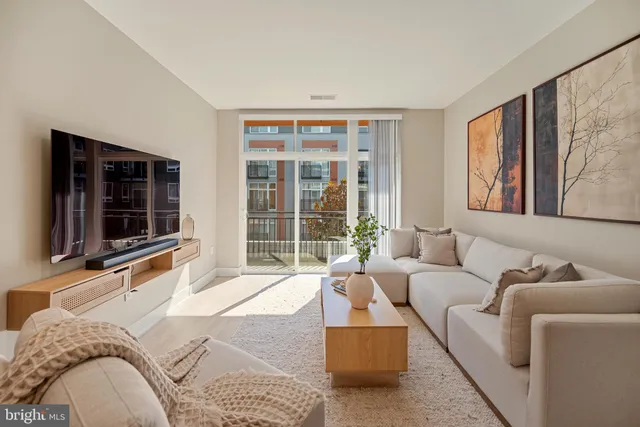 a large kitchen with kitchen island granite countertop lots of white cabinets appliances and furniture