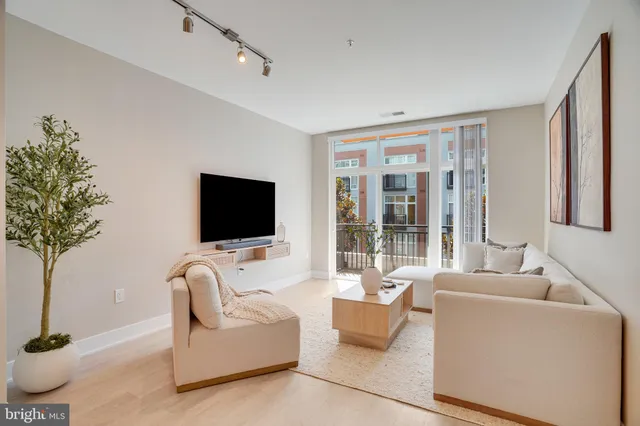 a living room with furniture window and flat screen tv