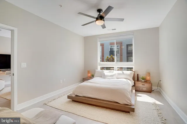 a bedroom with a bed and a potted plant