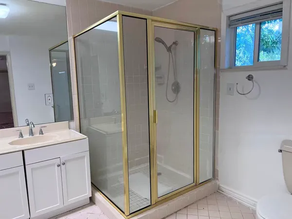 a bathroom with a shower sink and mirror
