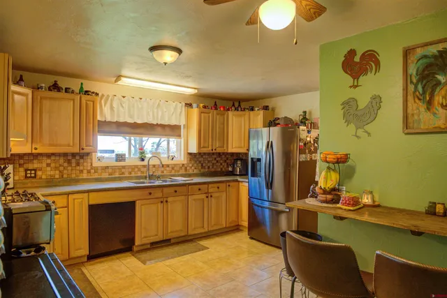 a kitchen with stainless steel appliances granite countertop a sink and cabinets
