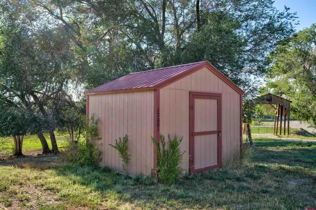a front view of a house with a garden and tree