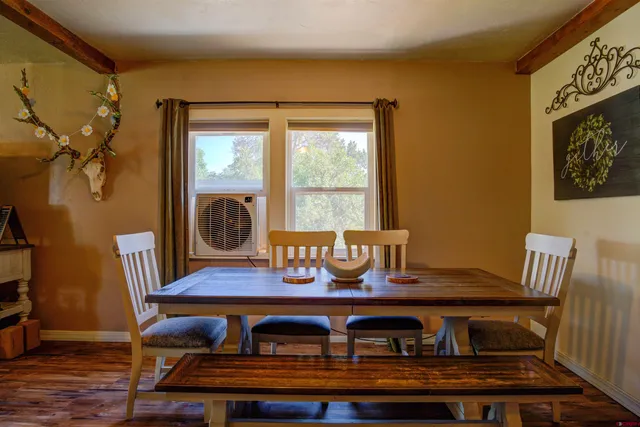 a view of table and chairs in wooden floor