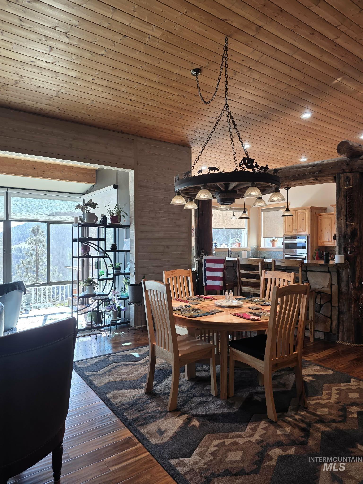 809 River Pointe Lane Lenore, ID 83541 - Photo 15 of 43 Dining area featuring dark wood-style flooring, wood ceiling, wood walls, and recessed lighting