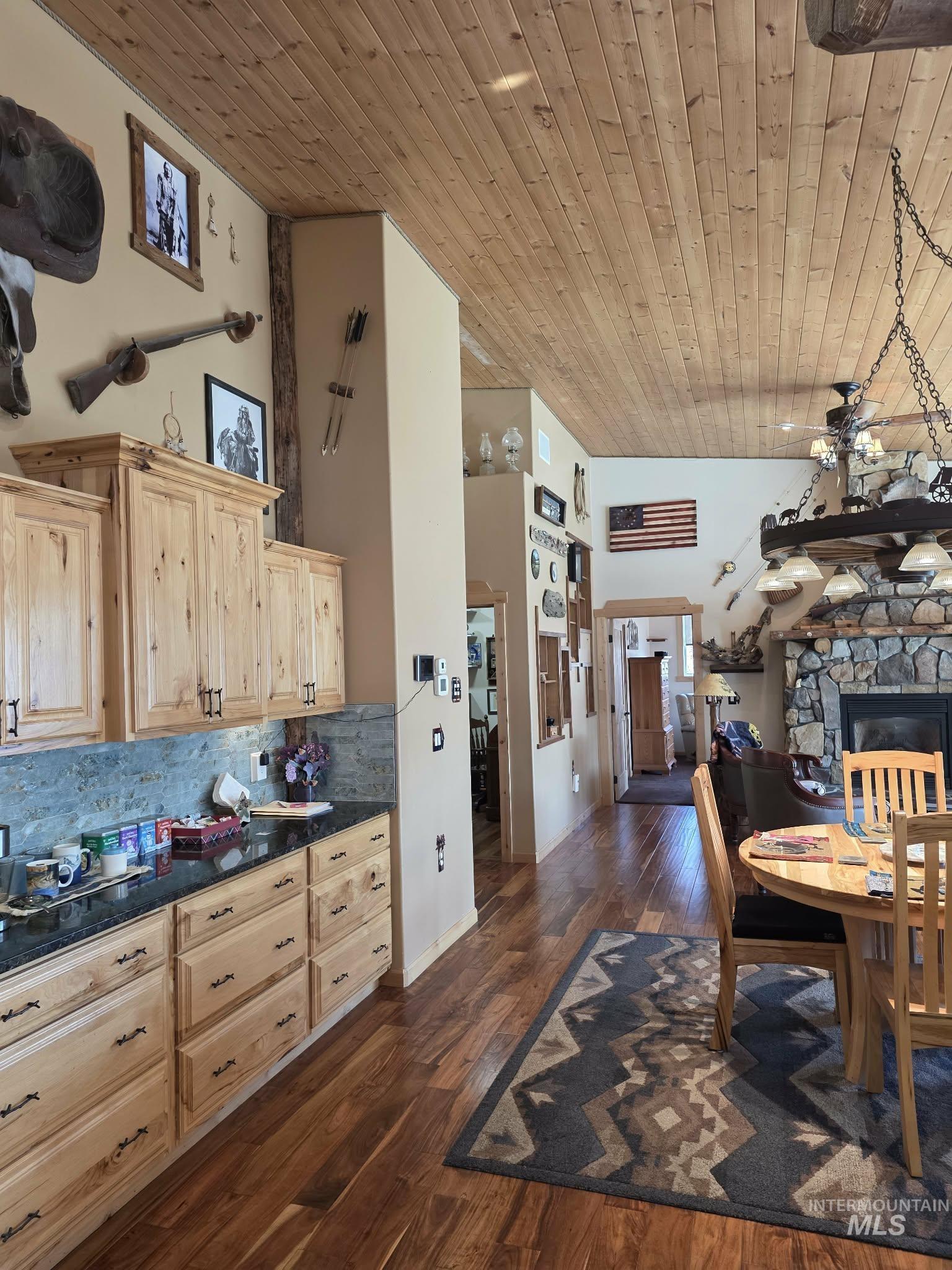 809 River Pointe Lane Lenore, ID 83541 - Photo 43 of 43 Kitchen featuring light wood finish cabinets, a high wooden ceiling, dark wood-type flooring, open floor plan, and a fireplace
