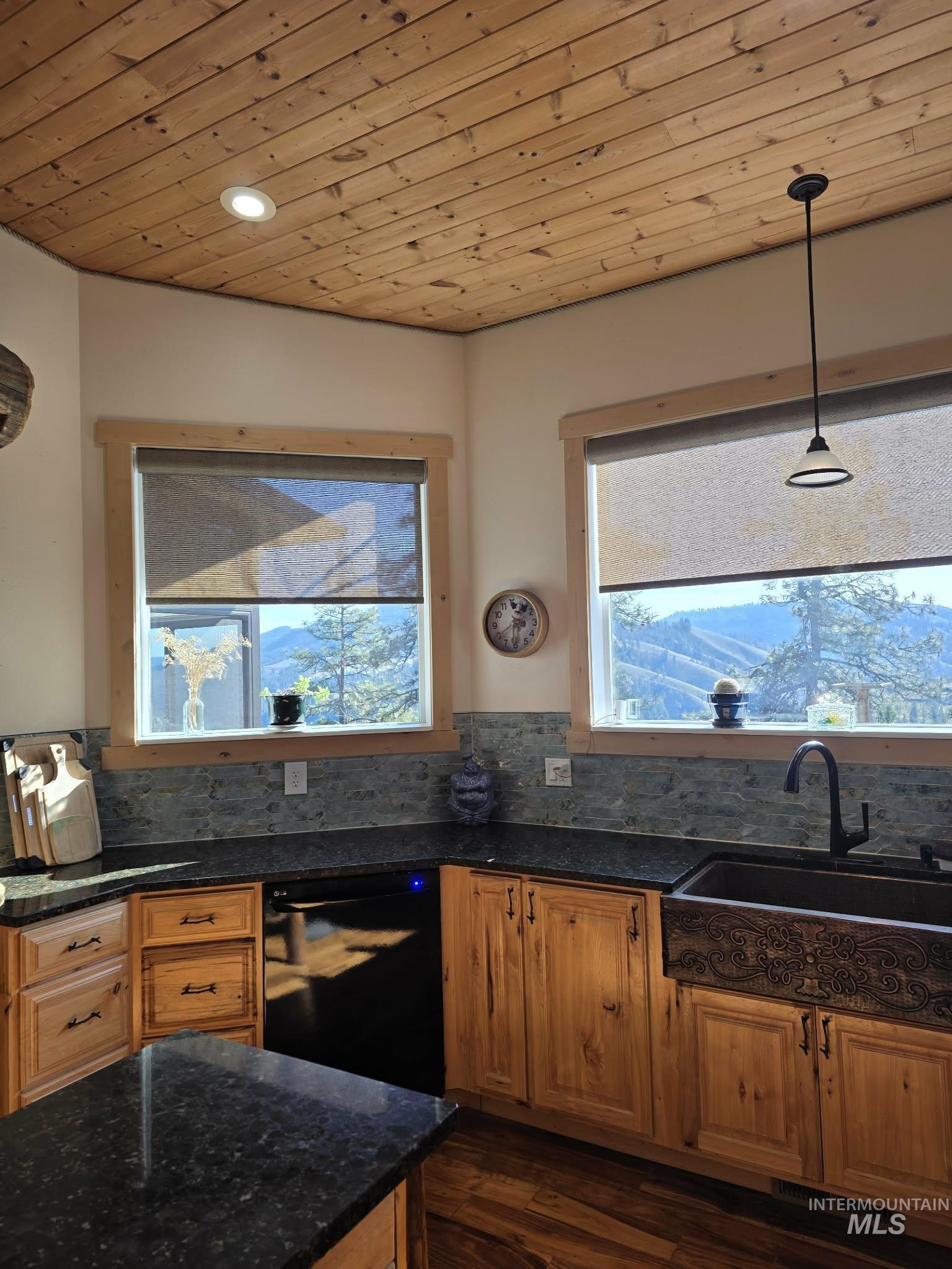 809 River Pointe Lane Lenore, ID 83541 - Photo 22 of 43 Kitchen featuring wood ceiling, dark stone countertops, wood finish cabinetry, dishwasher, and decorative light fixtures