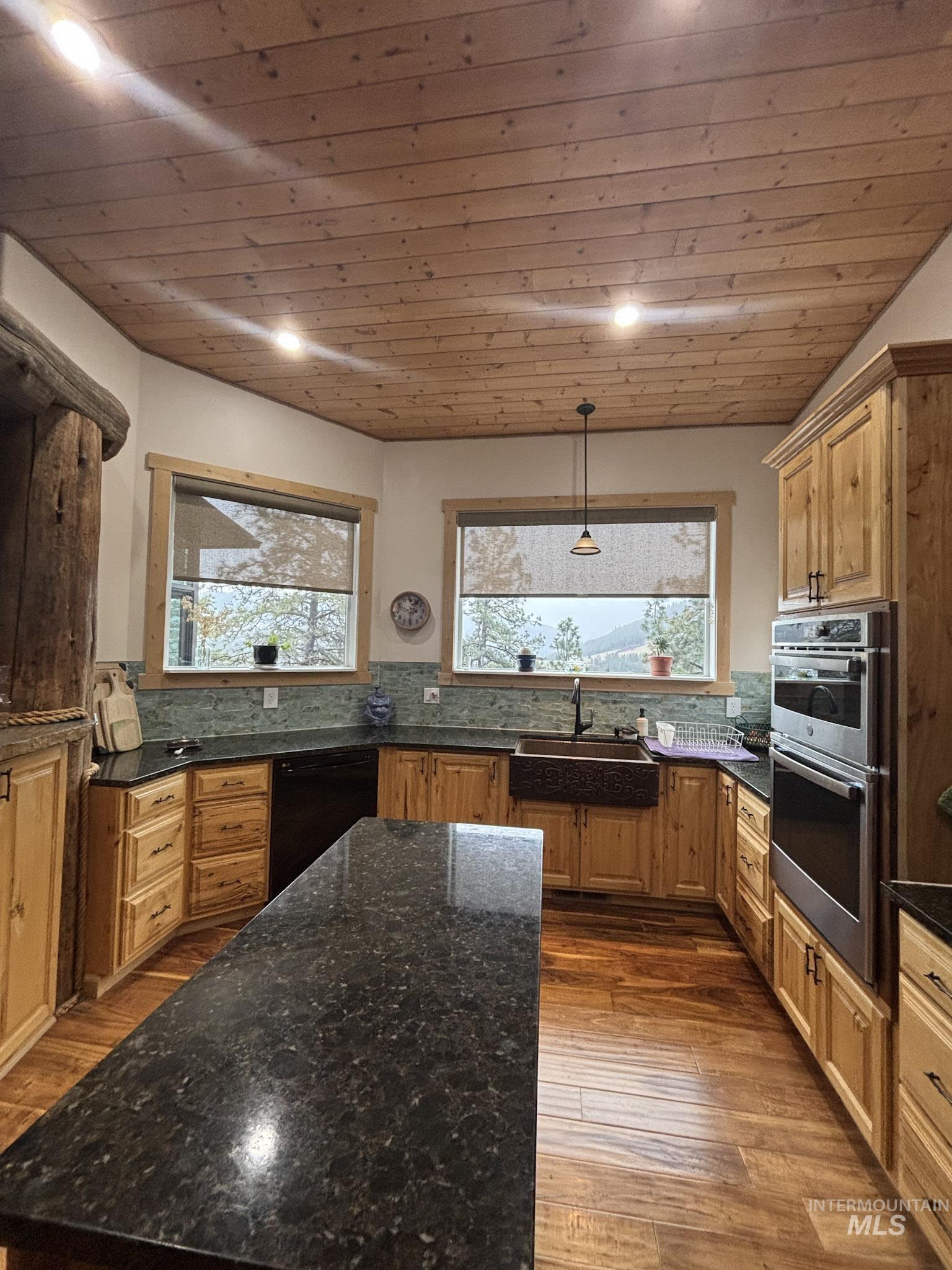 809 River Pointe Lane Lenore, ID 83541 - Photo 23 of 43 Kitchen featuring tasteful backsplash, stainless steel double oven, dark wood-style floors, dishwasher, and wood ceiling