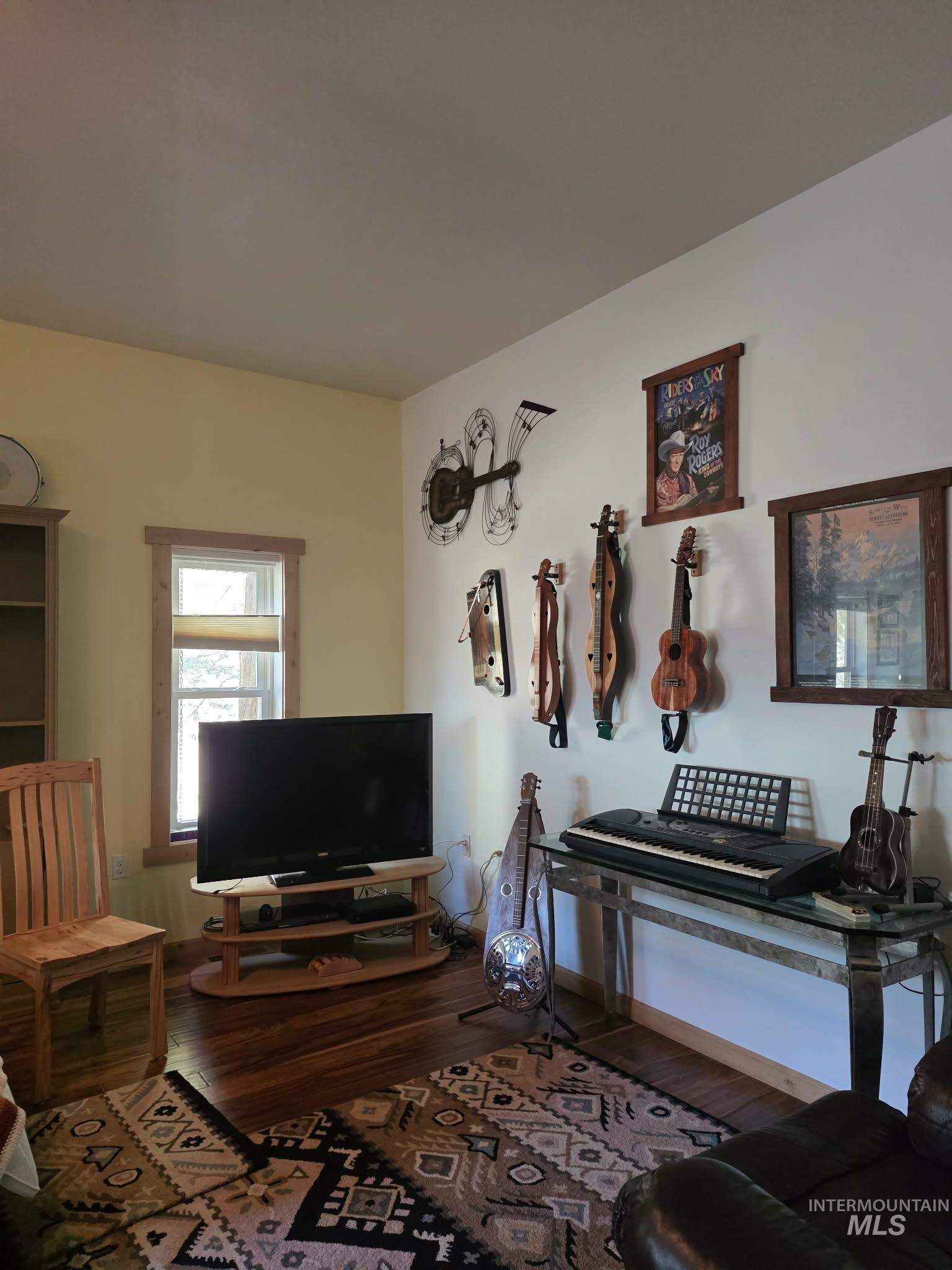 809 River Pointe Lane Lenore, ID 83541 - Photo 29 of 43 Living room featuring dark wood-type flooring and baseboards