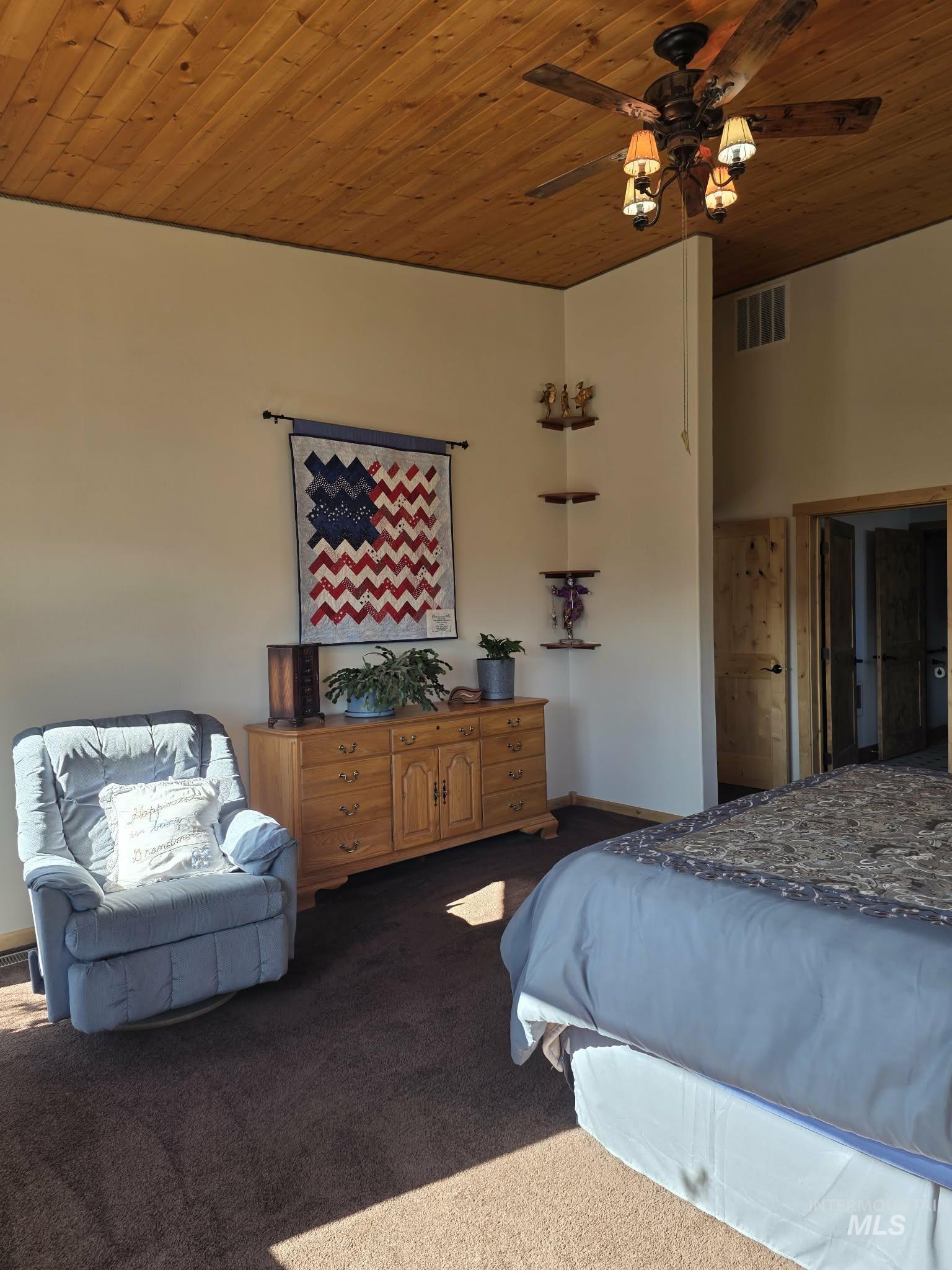 809 River Pointe Lane Lenore, ID 83541 - Photo 35 of 43 Bedroom featuring wooden ceiling, dark colored carpet, and ceiling fan