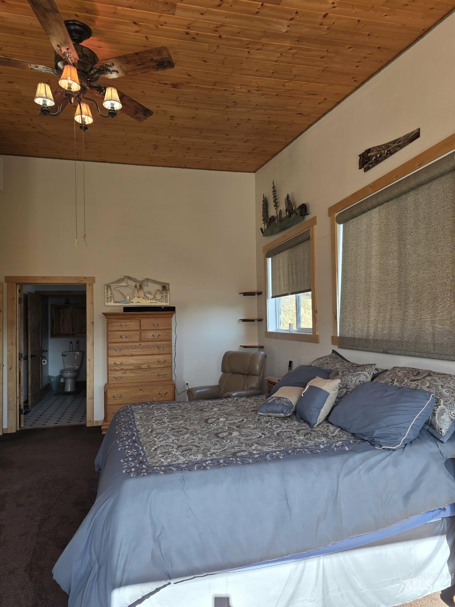 809 River Pointe Lane Lenore, ID 83541 - Photo 36 of 43 Bedroom with wooden ceiling, dark colored carpet, and a ceiling fan