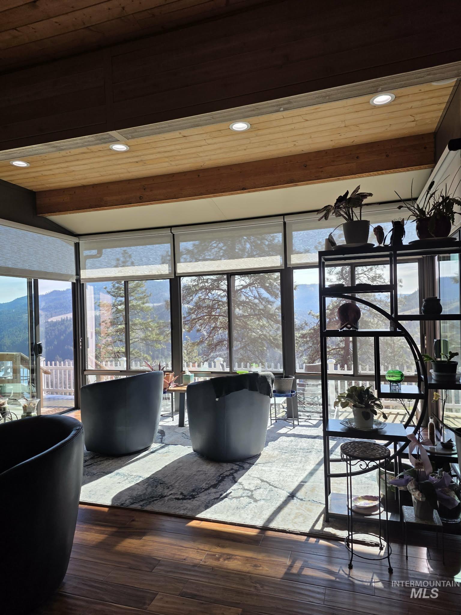 809 River Pointe Lane Lenore, ID 83541 - Photo 9 of 43 Living area featuring hardwood / wood-style flooring, recessed lighting, healthy amount of natural light, a mountain view, and wooden ceiling