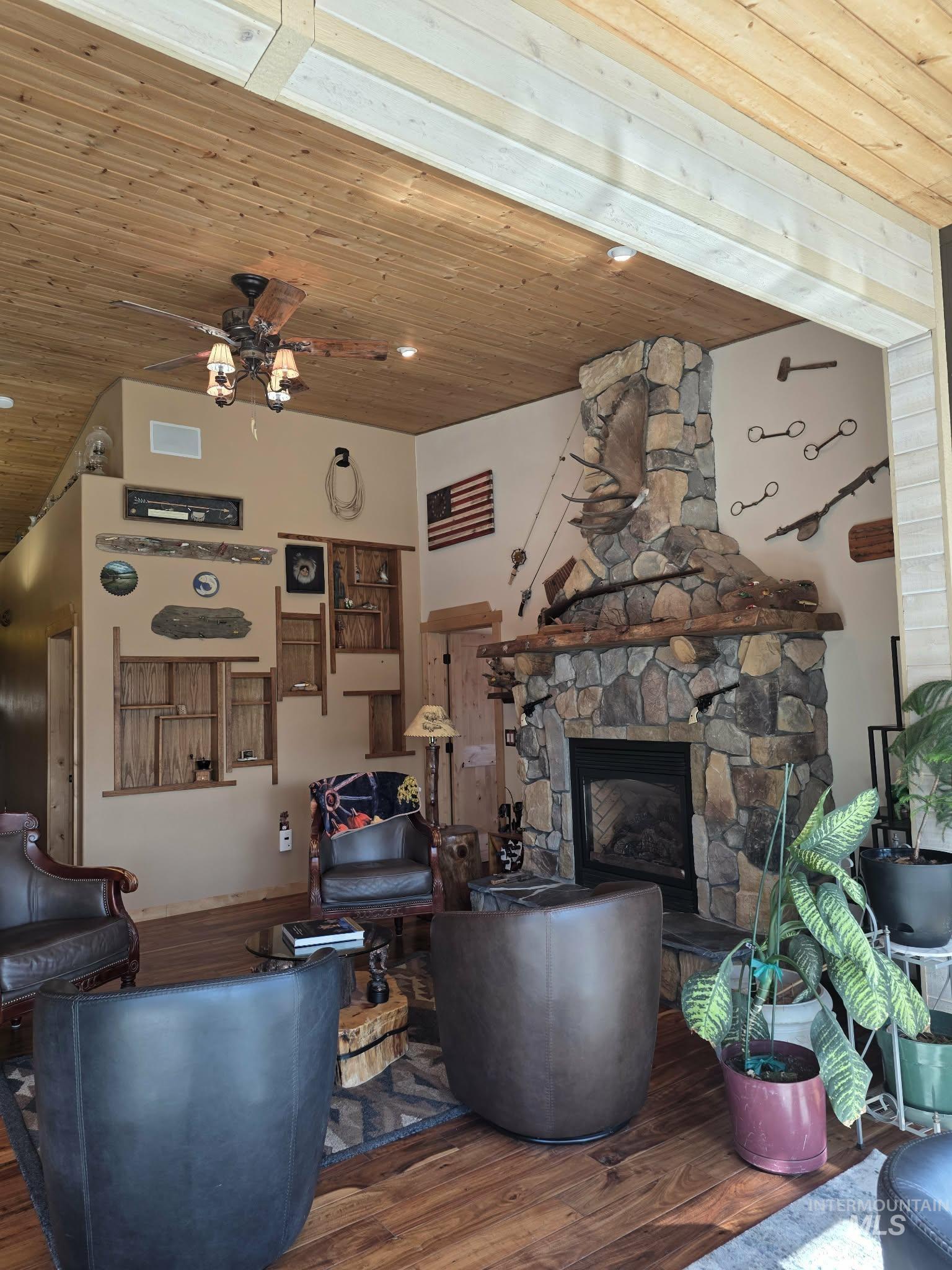 809 River Pointe Lane Lenore, ID 83541 - Photo 10 of 43 Living room featuring wood ceiling, wood finished floors, ceiling fan, and a fireplace