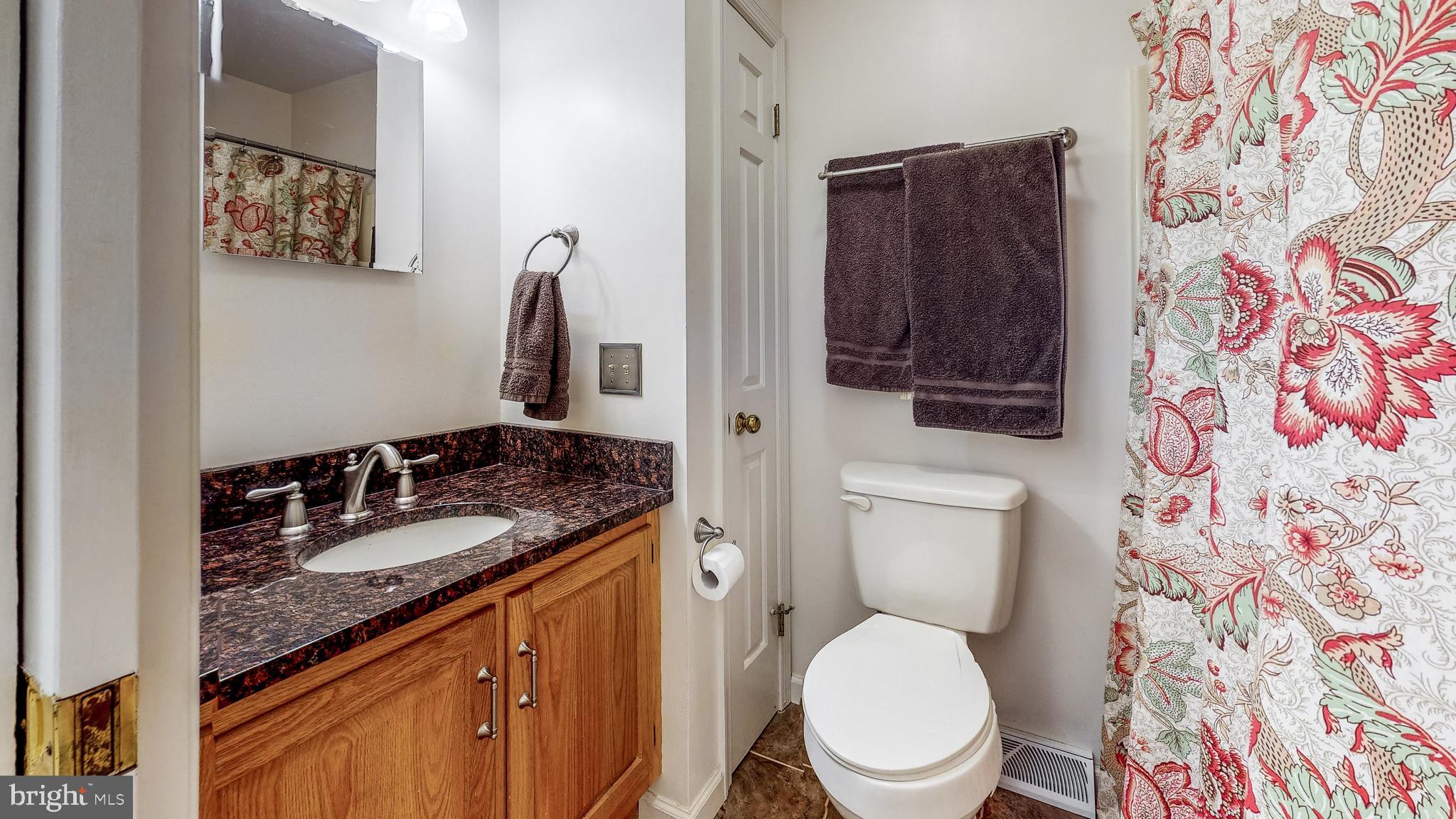 5362 Field Pointe Drive Spring Grove, PA 17362 - Photo 24 of 43 a bathroom with a granite countertop toilet sink and mirror