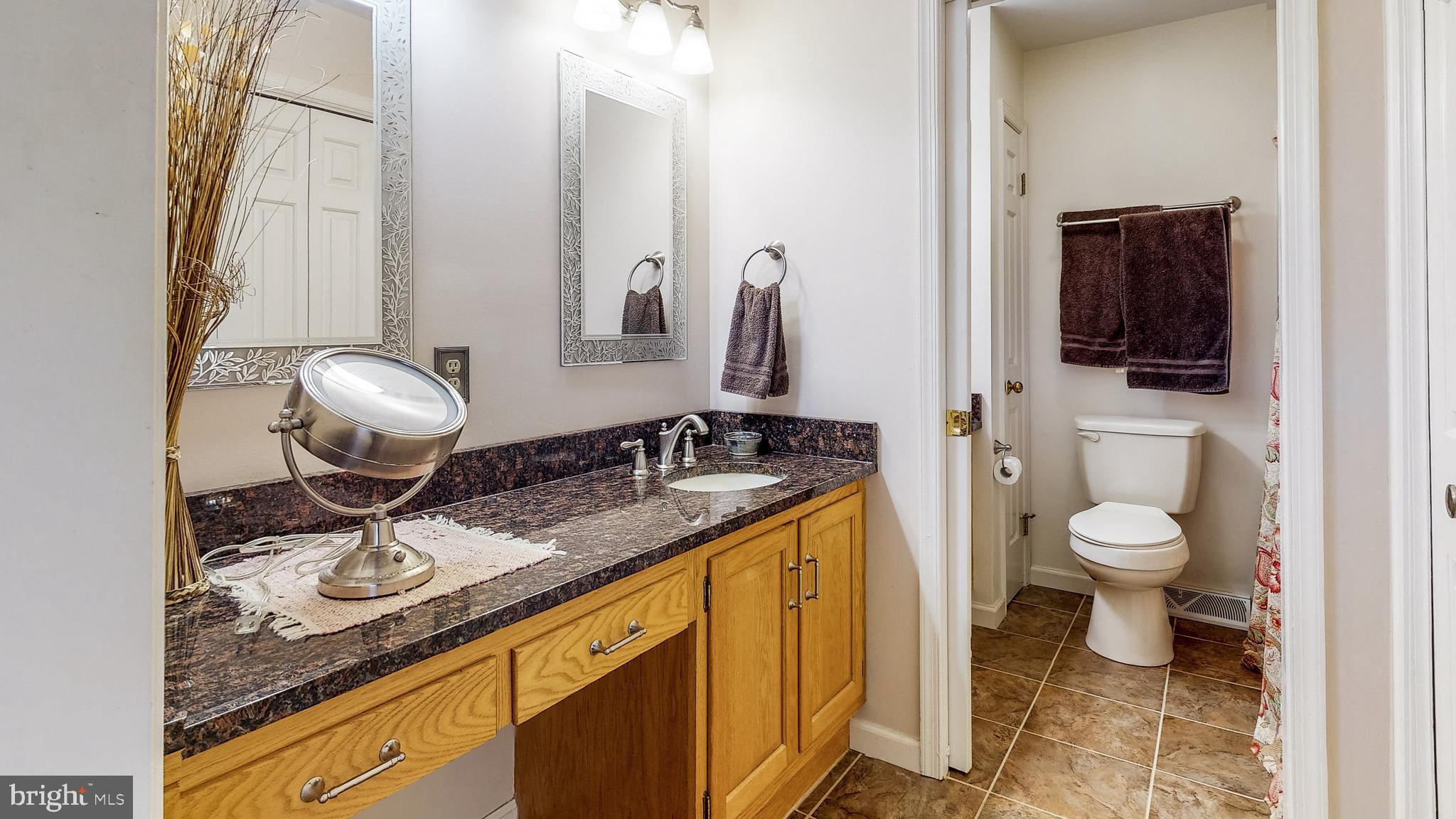 5362 Field Pointe Drive Spring Grove, PA 17362 - Photo 25 of 43 a bathroom with a granite countertop toilet sink and mirror
