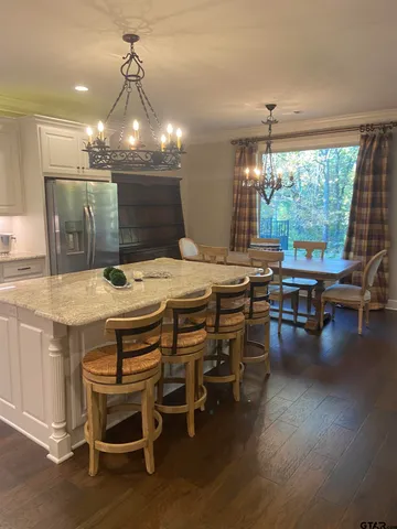 a dining table with chairs and wooden floor