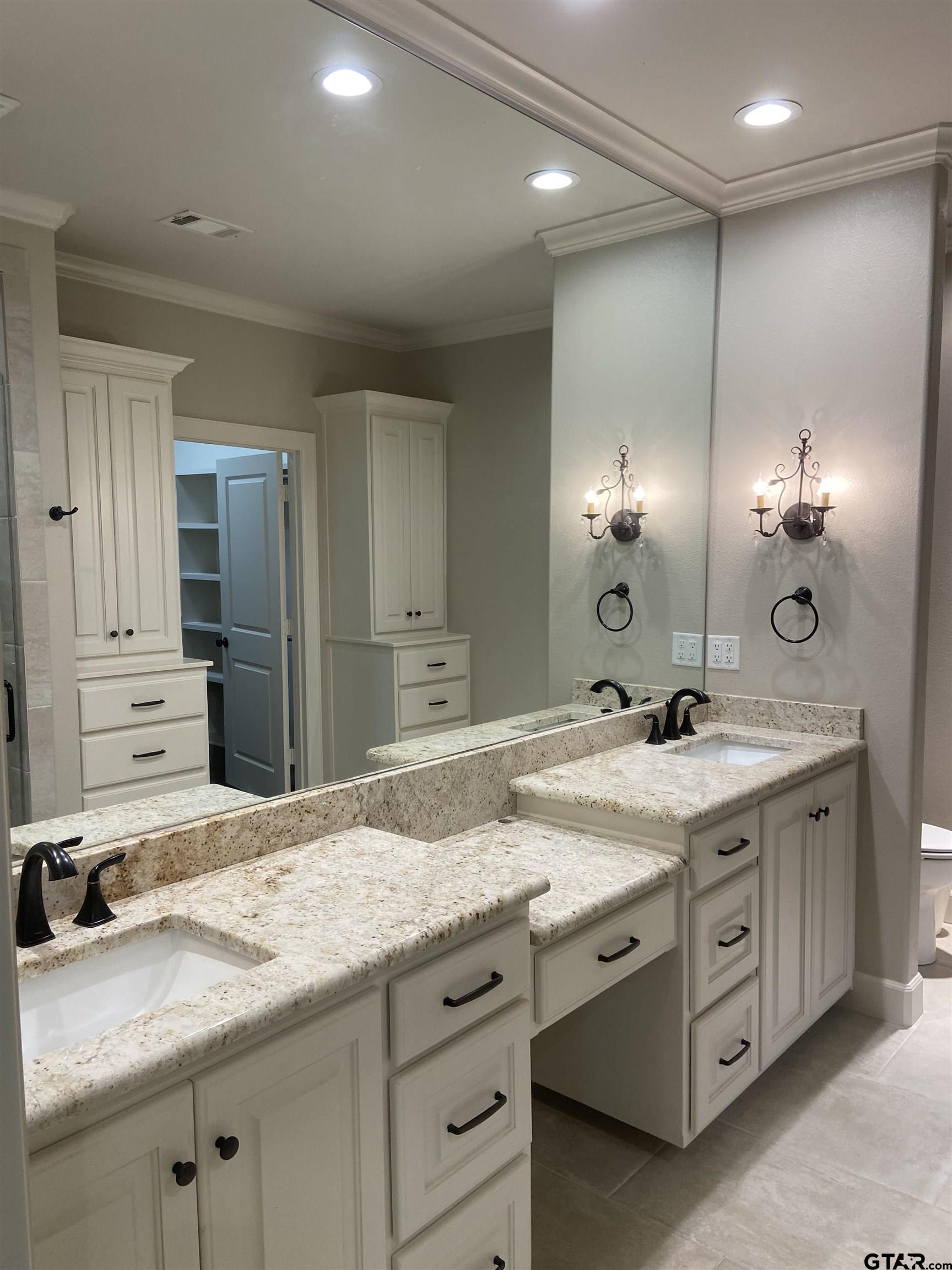 16864 Easy Street Flint, TX 75762 - Photo 23 of 34 a bathroom with a granite countertop sink double vanity and a large mirror