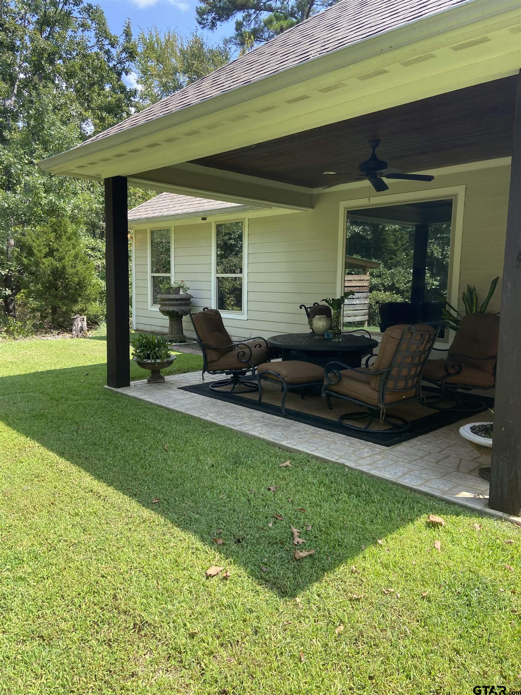 16864 Easy Street Flint, TX 75762 - Photo 30 of 34 a view of an house with backyard porch and furniture