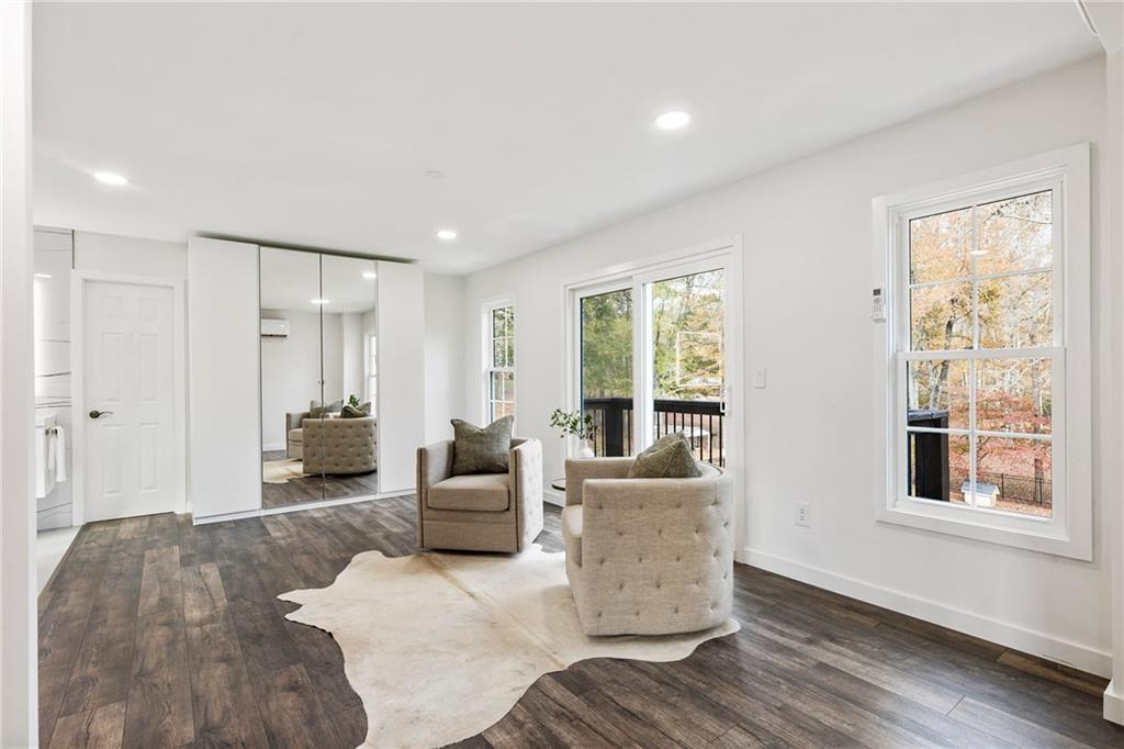 14440 Cogburn Road Alpharetta, GA 30004 - Photo 29 of 62 a living room with furniture and large windows