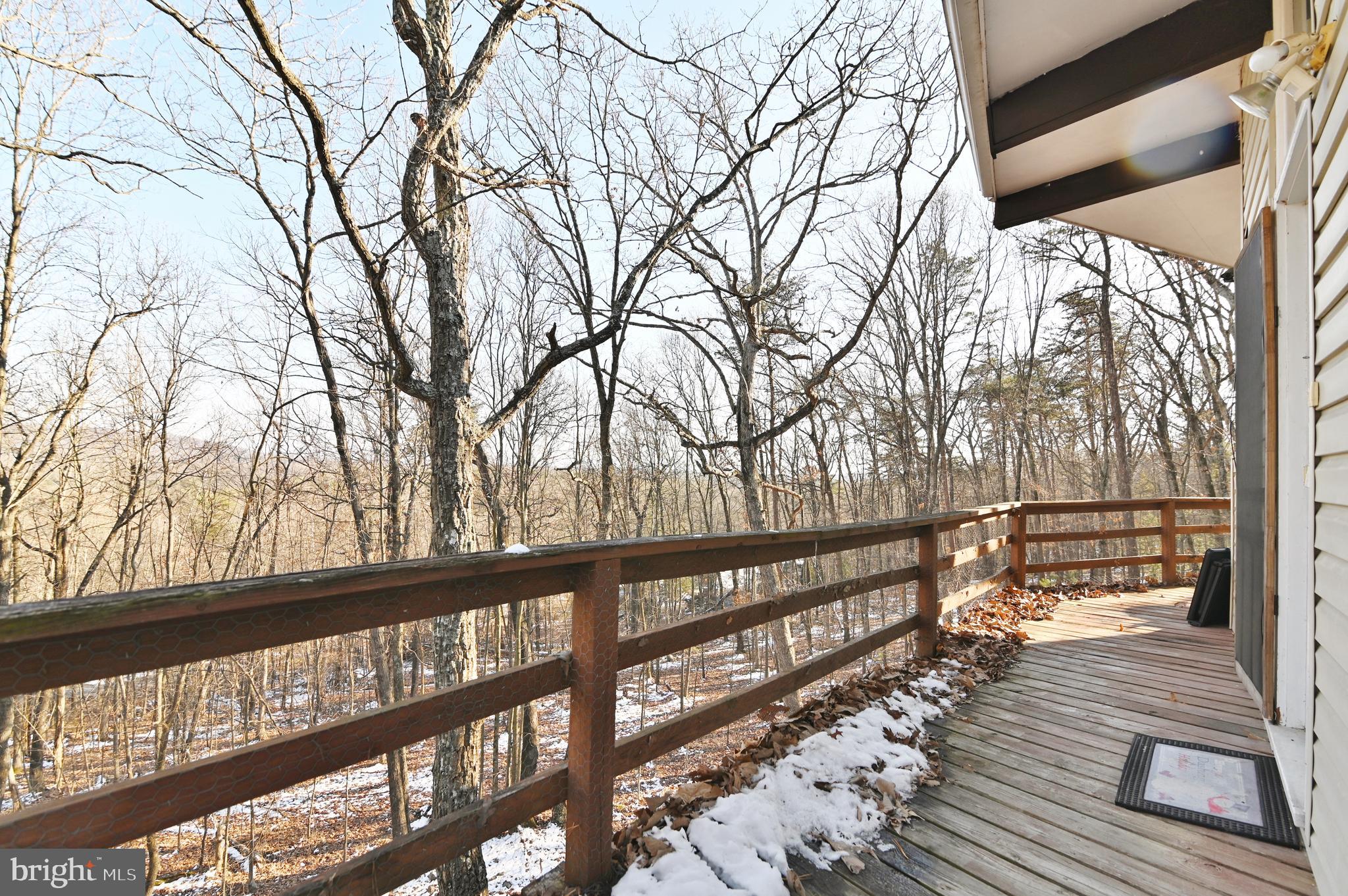 8148 Supinlick Ridge Road Mount Jackson, VA 22842 - Photo 20 of 39 a view of a balcony with wooden floor and bench